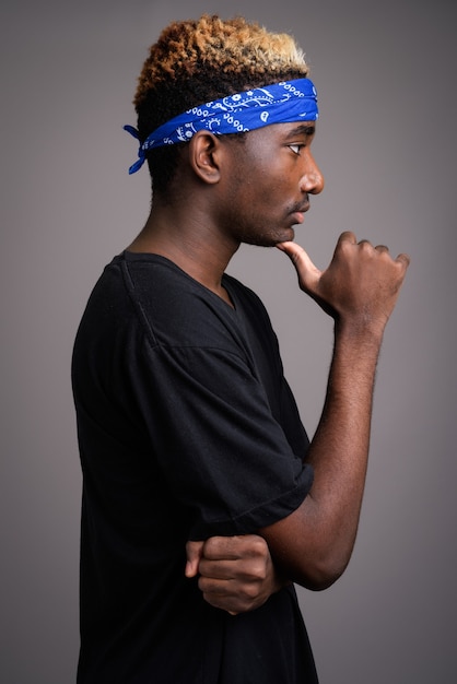 Young man wearing blue bandanna as headband