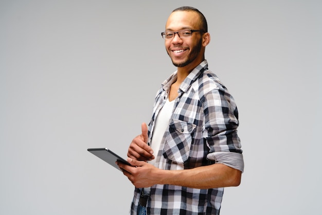 Young man wearing a casual shirt over gray background