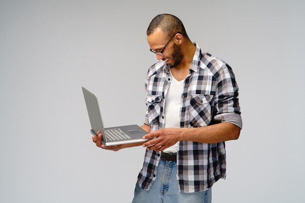 Young man wearing a casual shirt over gray background