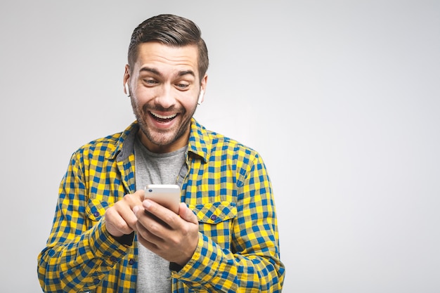 Young man wearing a casual shirt using the phone