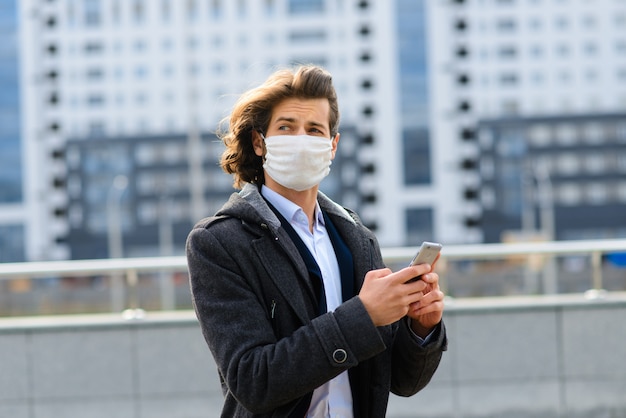 Young man wearing a face mask outside