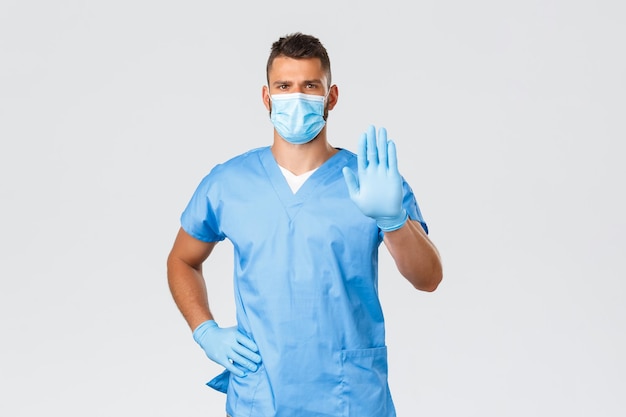 Young man wearing mask against white background