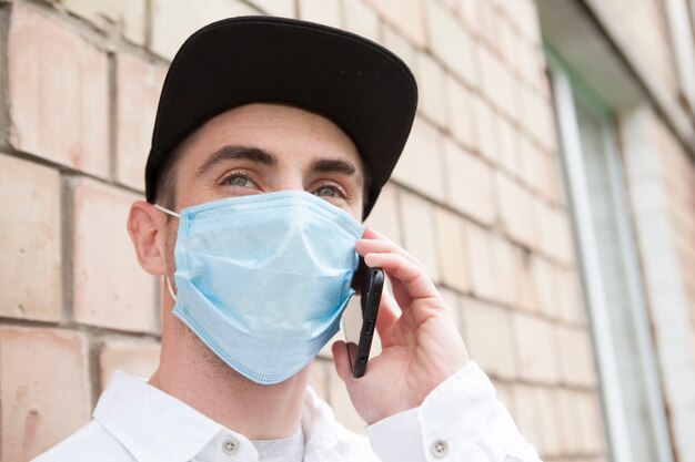 Young man wearing protective mask outdoors