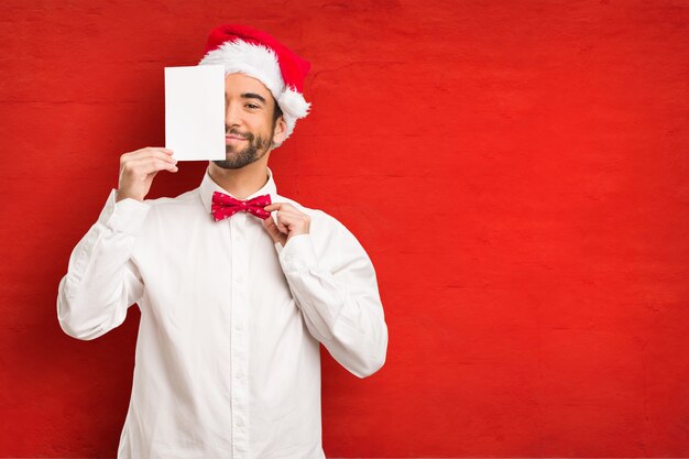 Young man wearing a santa claus hat on Christmas day