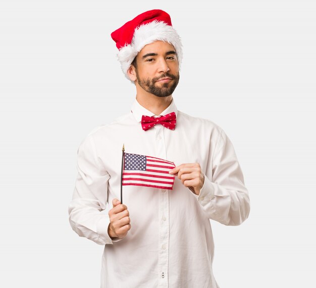 Young man wearing a santa claus hat on Christmas day