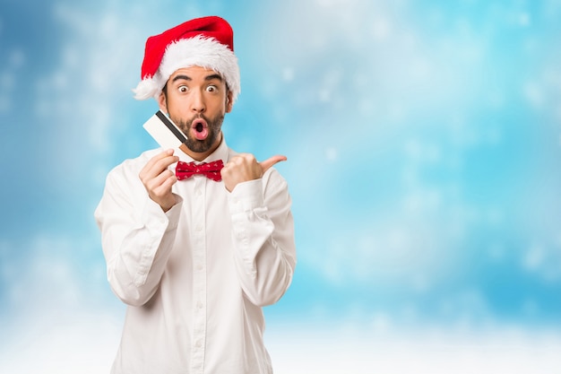 Young man wearing a santa claus hat on Christmas day