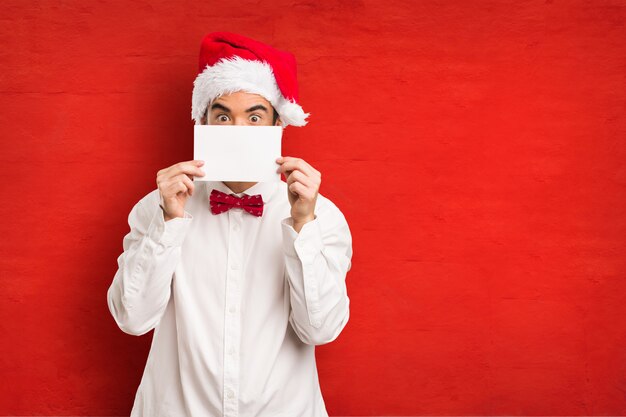 Young man wearing a santa claus hat on Christmas day