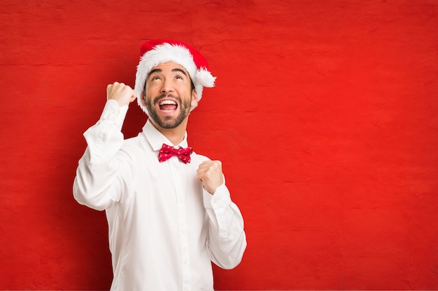 Young man wearing a santa claus hat on Christmas day