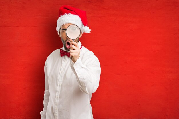 Young man wearing a santa claus hat on Christmas day