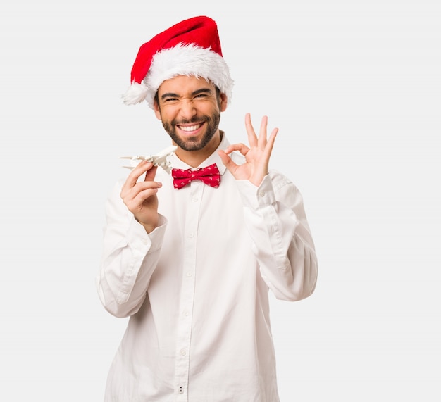 Young man wearing a santa claus hat on Christmas day