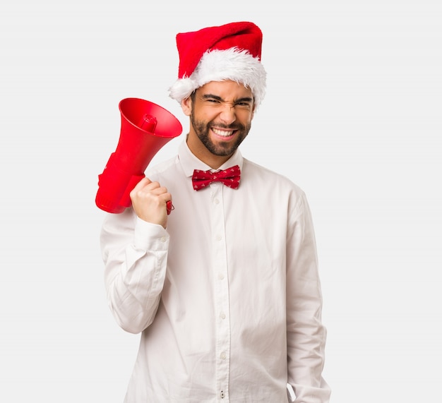 Young man wearing a santa claus hat on Christmas day