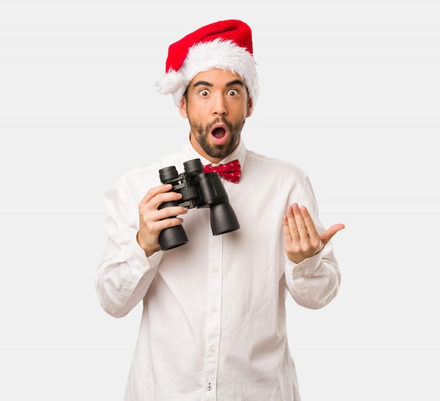 Young man wearing a santa claus hat on Christmas day