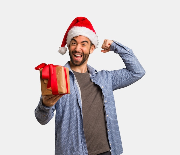 Young man wearing santa hat who does not surrender