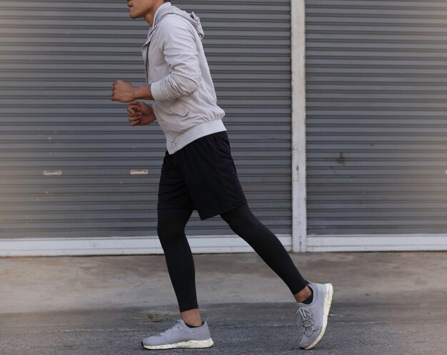 Young man wearing sportwear, jogging on road,for\
exercise,blurry light around