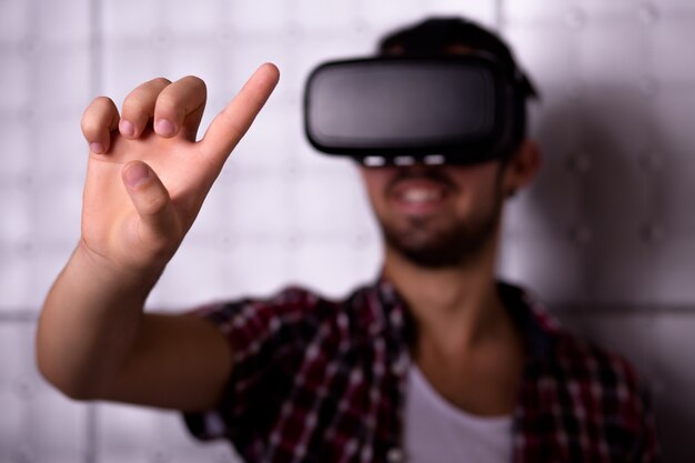 Young man wearing virtual reality glasses