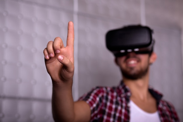 Young man wearing virtual reality glasses