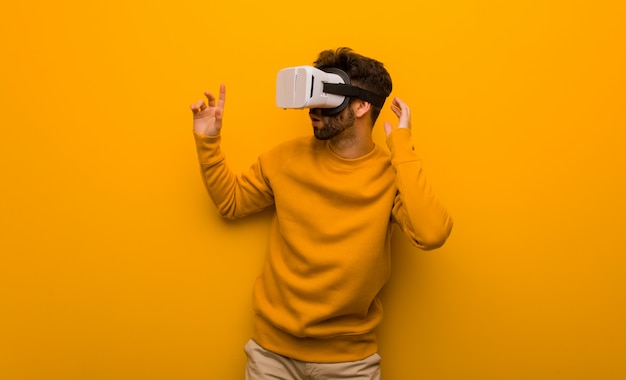 Young man wearing a virtual reality glasses