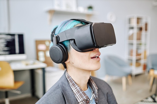 young man wearing vr headset in office working on immersive reality project