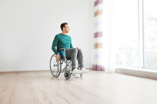 Young man in wheelchair indoors