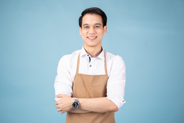 Young man in white shirt and beige apron