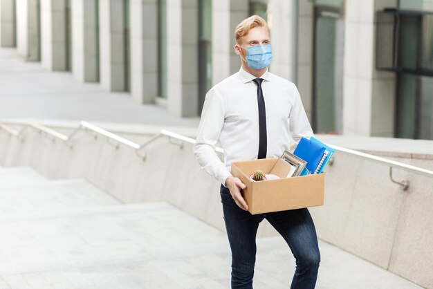 Young man in white shirt with surgical medical mask have a new job going to new better work