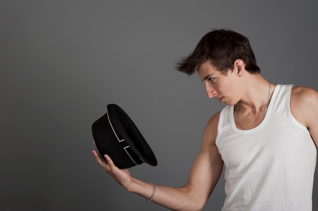 Young man in a white t-shirt with a black hat