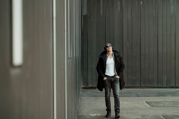 Young Man in the Winter City Streets with Headphones