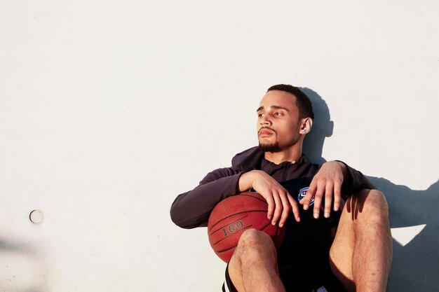 Young man with basketball having a break