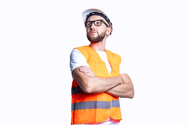 Young man with a beard in casual clothes crossing his arms on a light background