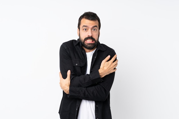 Young man with beard over isolated  freezing