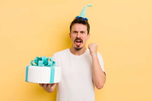 Young man with a birthday cake