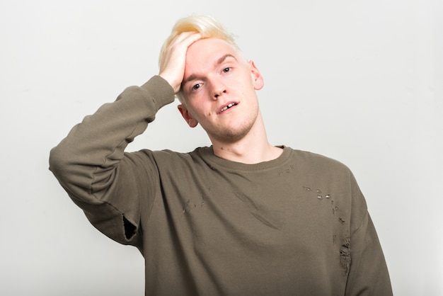 young man with blond hair on white