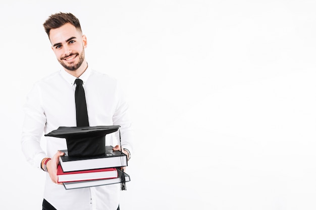 Young man with books and mortarboard