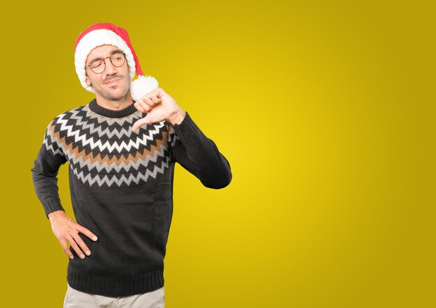 Young man with Christmas hat gesturing