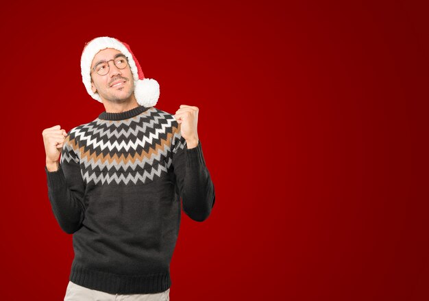 Young man with Christmas hat gesturing