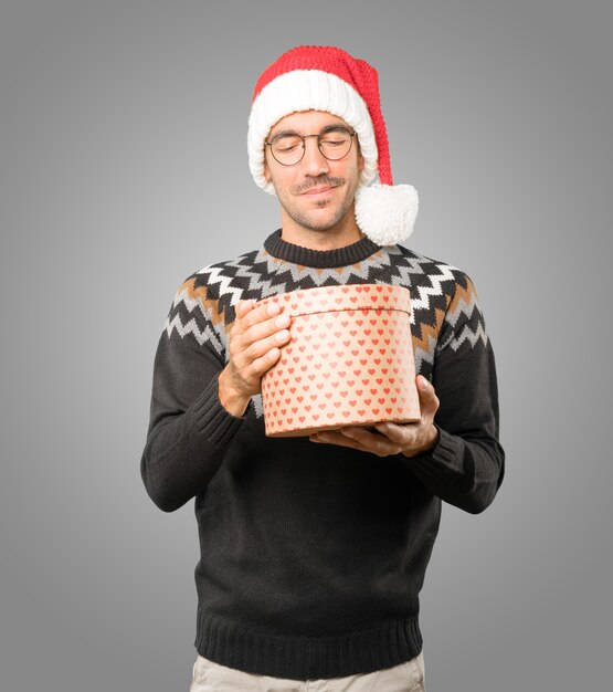 Young man with Christmas hat gesturing