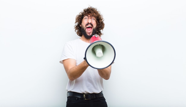 Young man with crazy hair in motion and shouting 