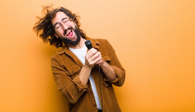 Giovane con capelli folli in movimento cantando