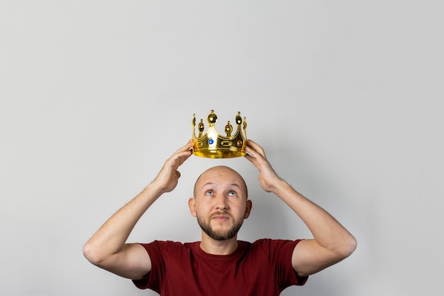 Young man with a crown on his head isolated