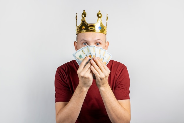 Young man with a crown on his head isolated