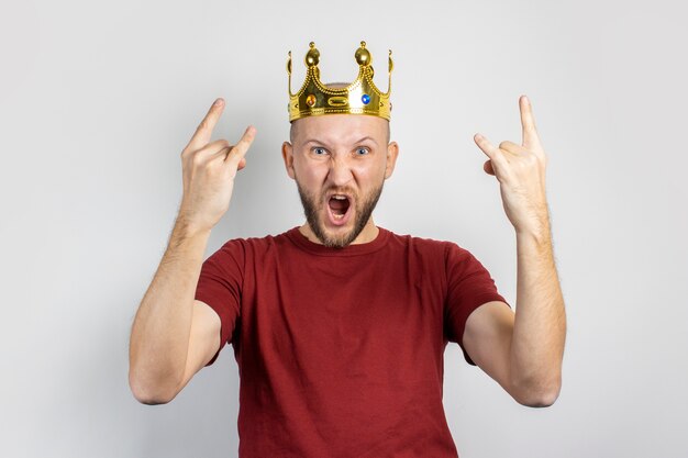 Young man with a crown on his head isolated