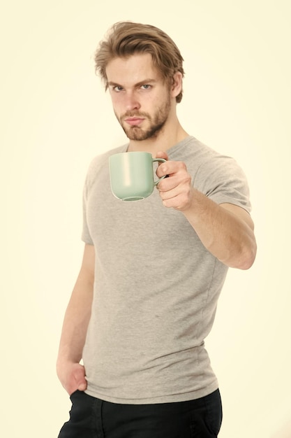 Young man with cup drinking coffee or tea