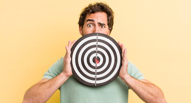 Young man with a darts target