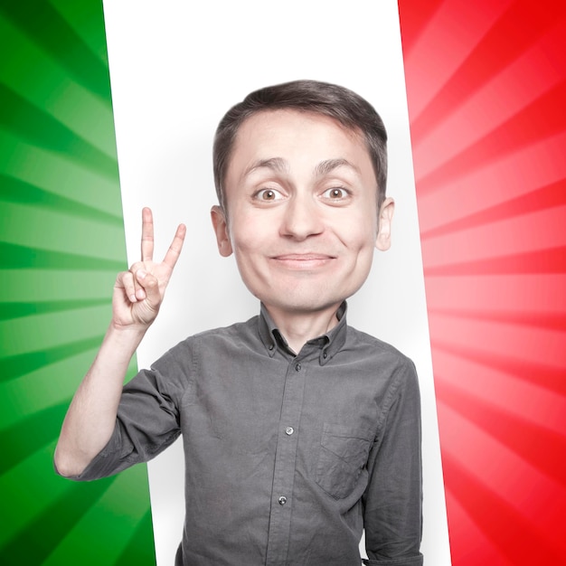 Photo young man with the fingers in a victory sign on background of the flag of italy