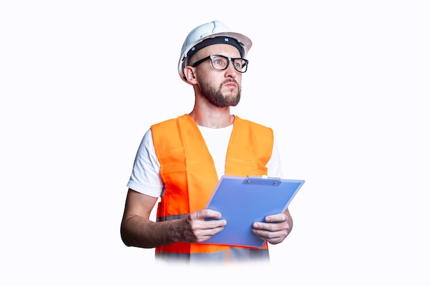 Young man with glasses in building clothes with a clipboard on a light background