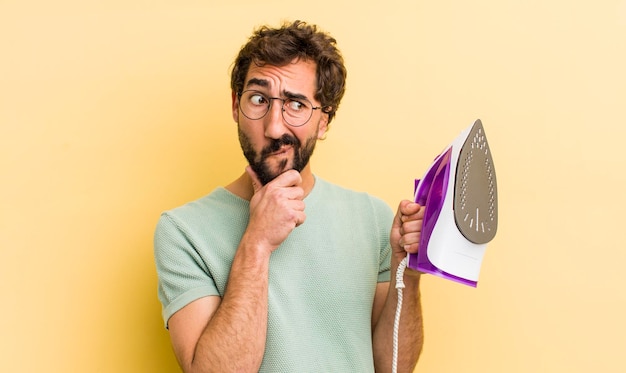 Young man with hand iron housekeeper concept