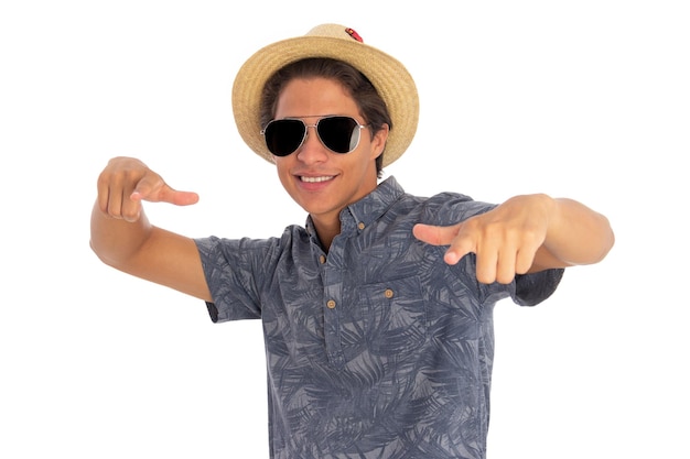 young man with hat and sunglasses in a funny attitude Concept of tourism and summer