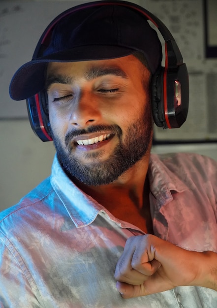 A young man with headphones listning music and enjoying