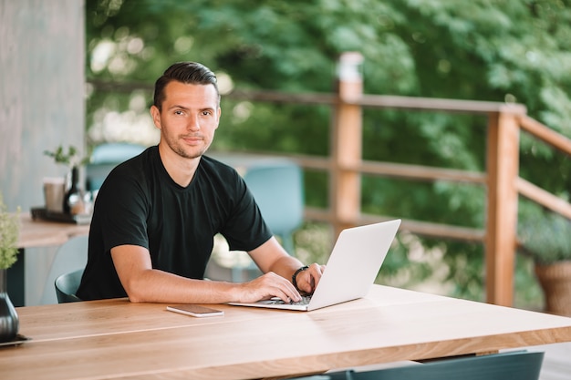 Young man with laptop works from home