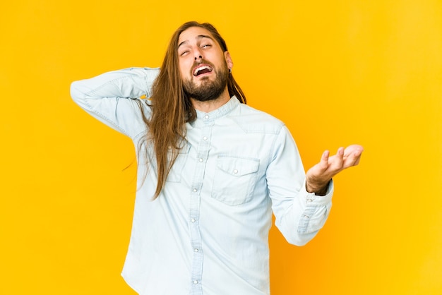 Young man with long hair look screaming with rage